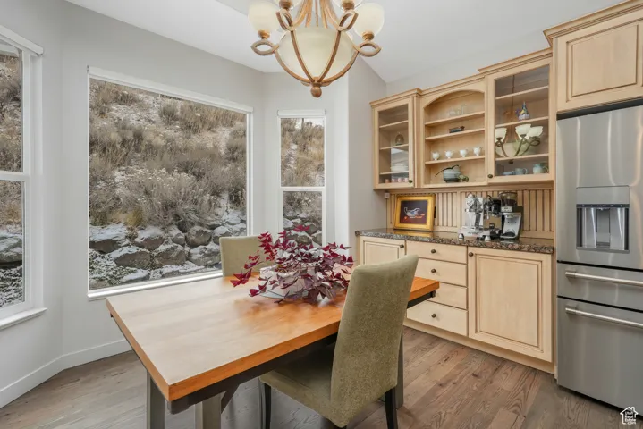 Dining area featuring hardwood / wood-style flooring and an inviting chandelier