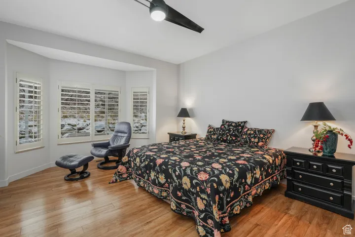 Bedroom with ceiling fan and light hardwood / wood-style flooring