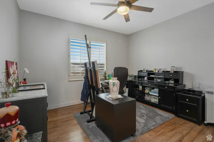 Office space featuring ceiling fan and dark wood-type flooring