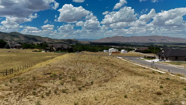 Expansive land parcel featuring open terrain and a distant mountainous backdrop