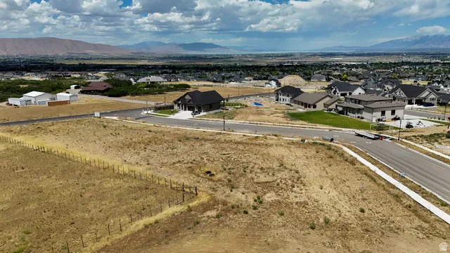 Expansive undeveloped land parcel featuring a wire fence boundary