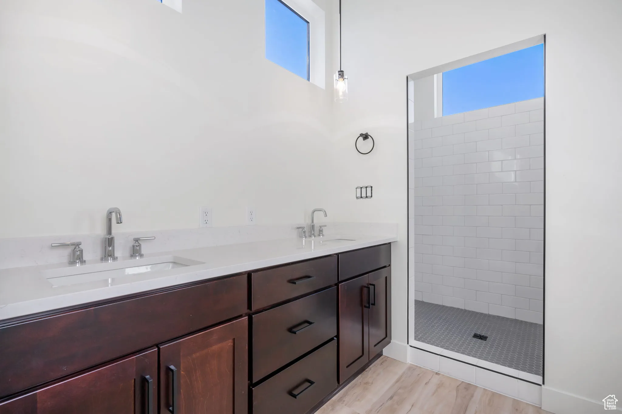 Bathroom featuring vanity, hardwood / wood-style flooring, and tiled shower