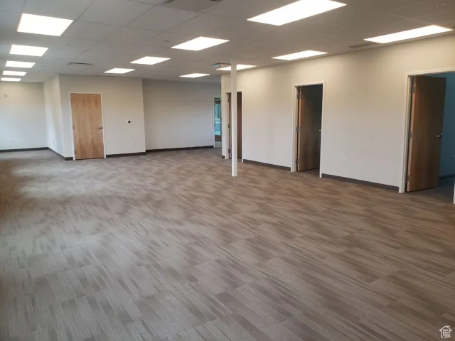 Carpeted empty room featuring a paneled ceiling
