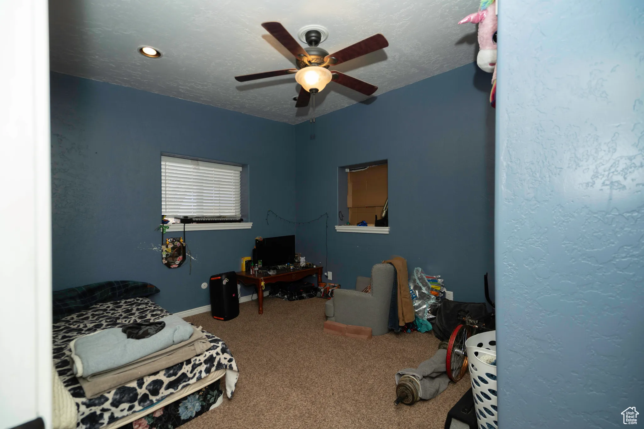 Bedroom featuring carpet, a textured ceiling, and ceiling fan