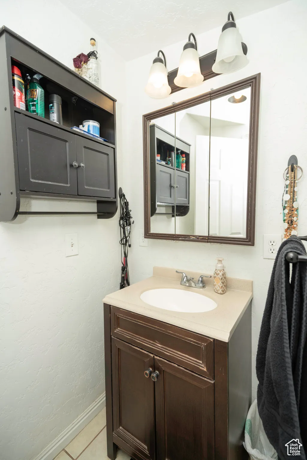 Bathroom featuring tile patterned flooring and vanity
