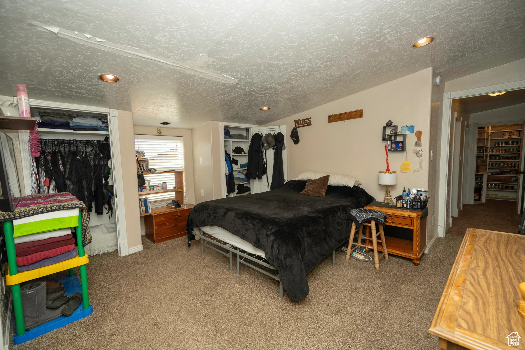 Carpeted bedroom featuring a closet and a textured ceiling