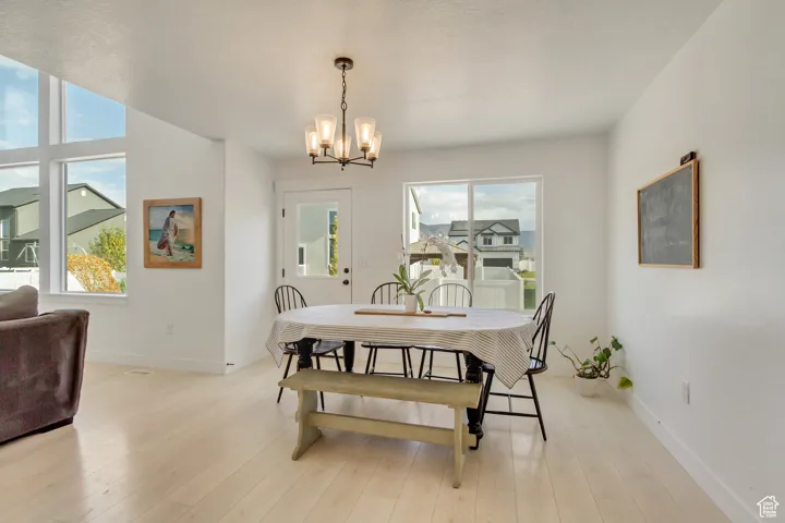 Dining room with a chandelier and light wood-type flooring