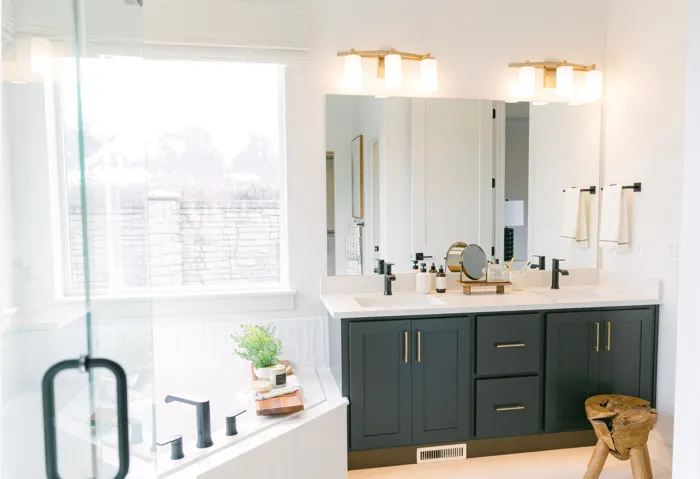 Bathroom featuring double vanity, a stall shower, and a bathtub