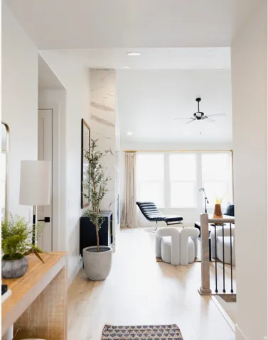 Living area featuring light wood-type flooring and a ceiling fan
