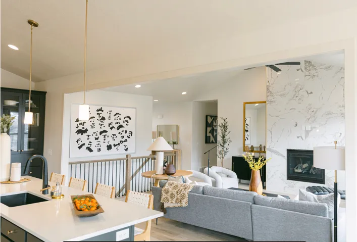 Living area featuring vaulted ceiling, light wood-style floors, a fireplace, and recessed lighting