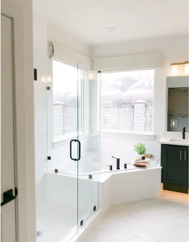 Bathroom featuring vanity, healthy amount of natural light, a bath, and light tile patterned flooring