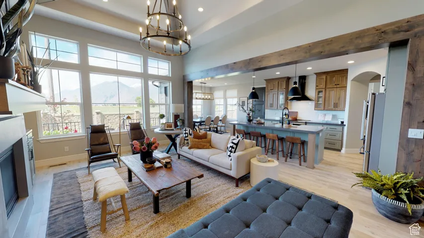 Living room with a mountain view, sink, a chandelier, and light hardwood / wood-style floors