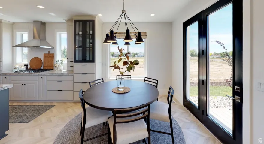 Dining area with light parquet floors and a wealth of natural light