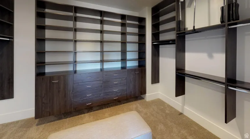 Spacious closet with light colored carpet
