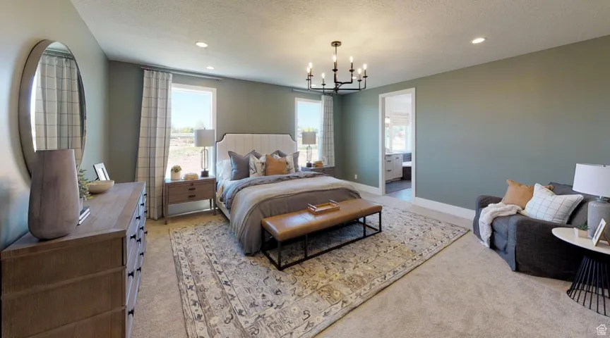 Carpeted bedroom featuring a chandelier, a textured ceiling, and ensuite bathroom