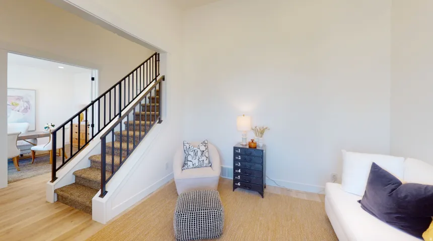 Staircase with wood finished floors and baseboards