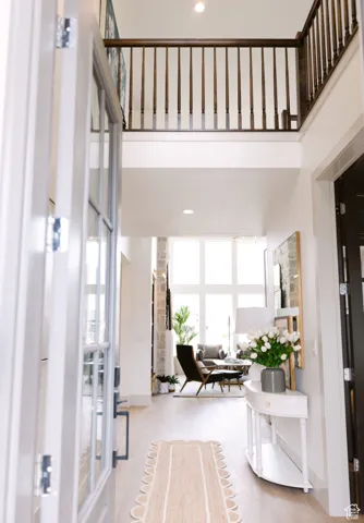 Foyer featuring plenty of natural light, light hardwood / wood-style floors, and a high ceiling