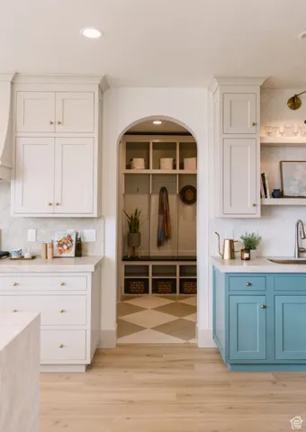 Mudroom with sink and light hardwood / wood-style flooring