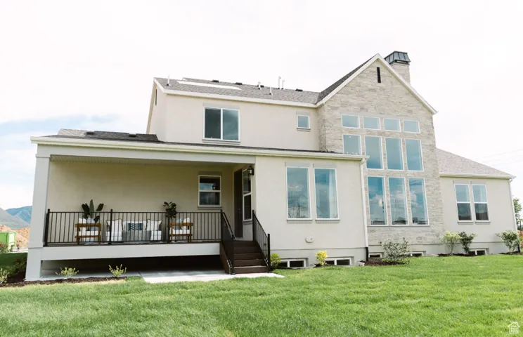 Rear view of house with a lawn