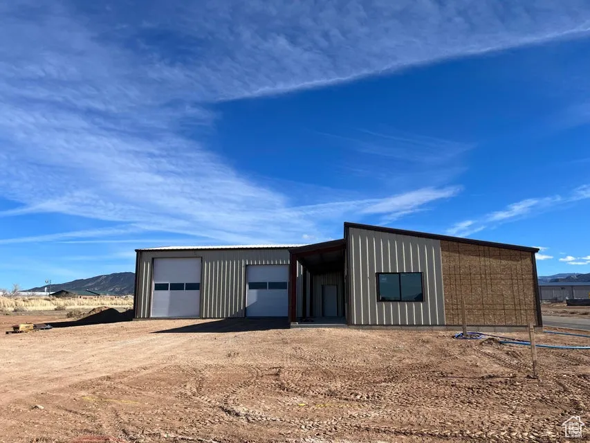 View of outdoor structure featuring a mountain view and a garage