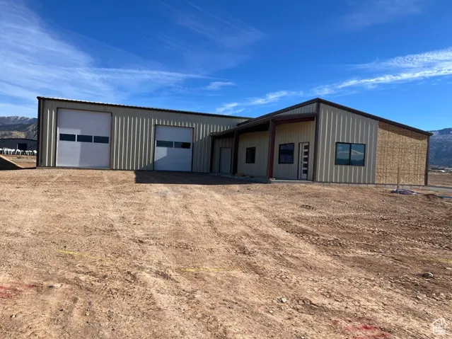 View of front of property featuring a mountain view and a garage