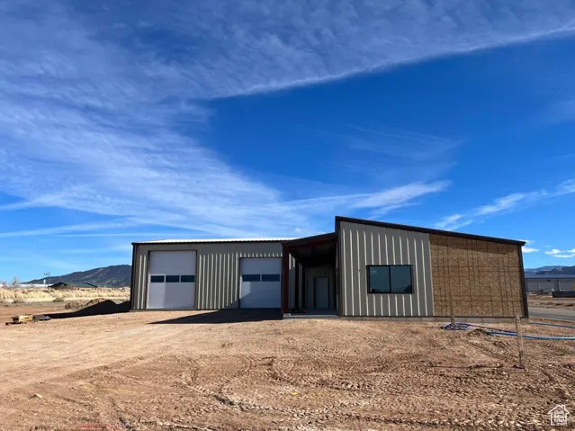 View of outdoor structure featuring a mountain view and a garage