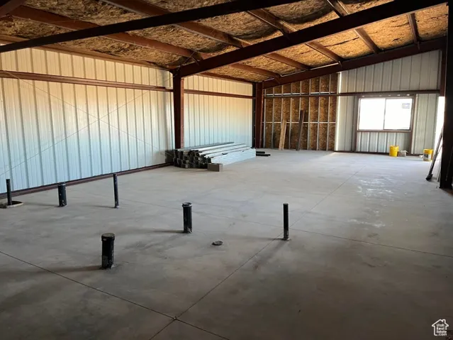 Miscellaneous room with concrete flooring and vaulted ceiling