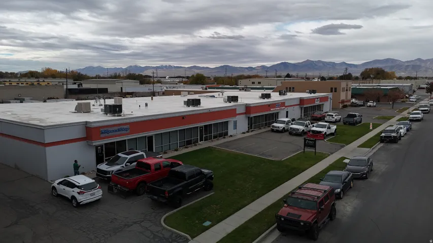 View of commercial location featuring a mountain view and uncovered parking
