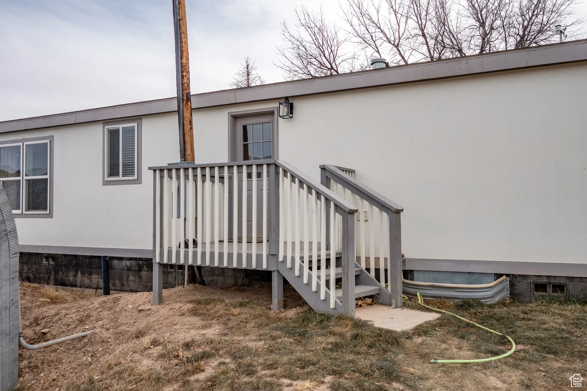 View of exterior entry featuring a wooden deck