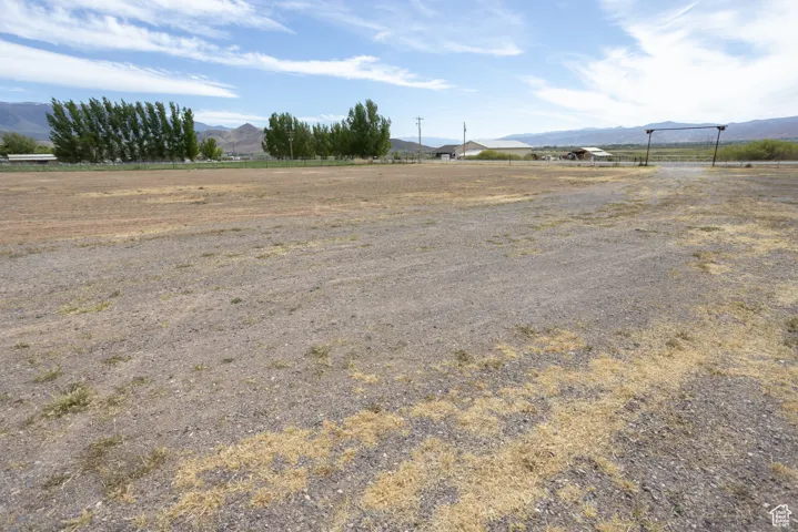 View of yard featuring a rural view and a mountain view