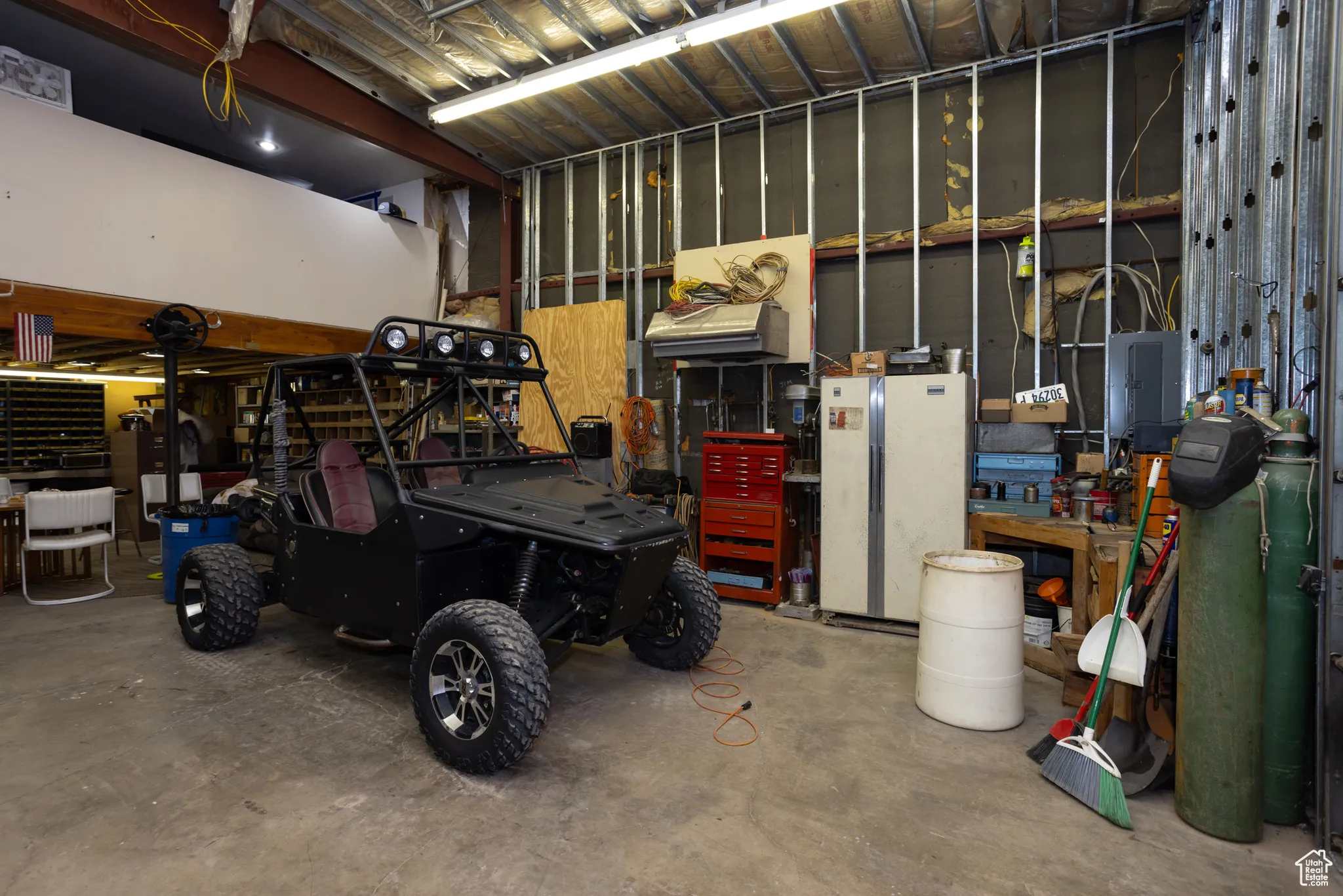 Garage with fridge and a workshop area