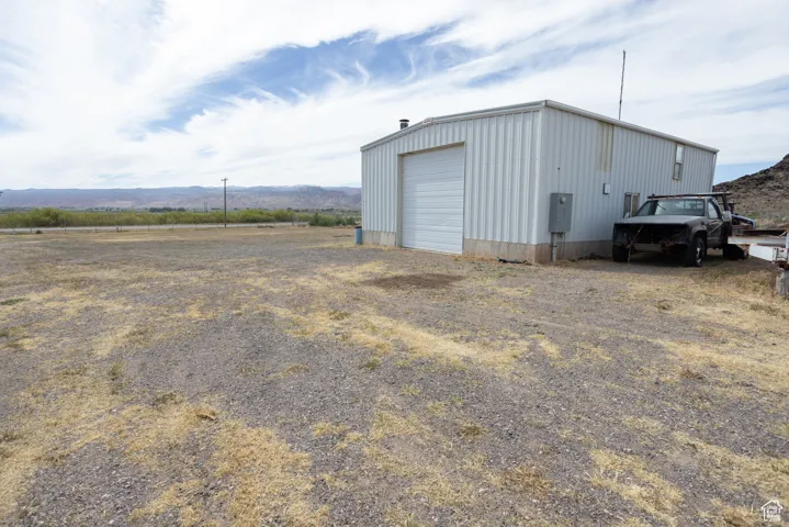 View of outbuilding featuring a garage and a mountain view