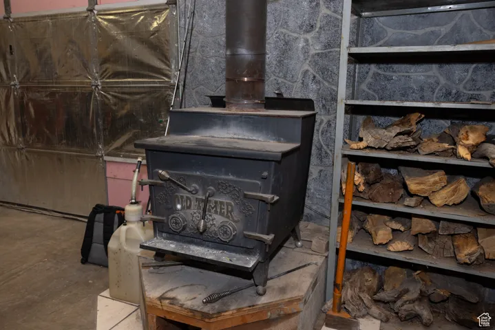 Interior details featuring concrete floors and a wood stove