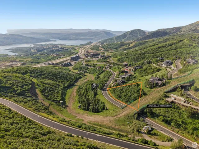 Aerial view of property's location with property parcel outlined and a water and mountain view