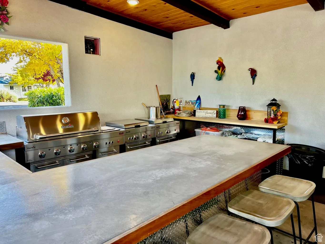 Kitchen with wood ceiling, a kitchen breakfast bar, and beam ceiling