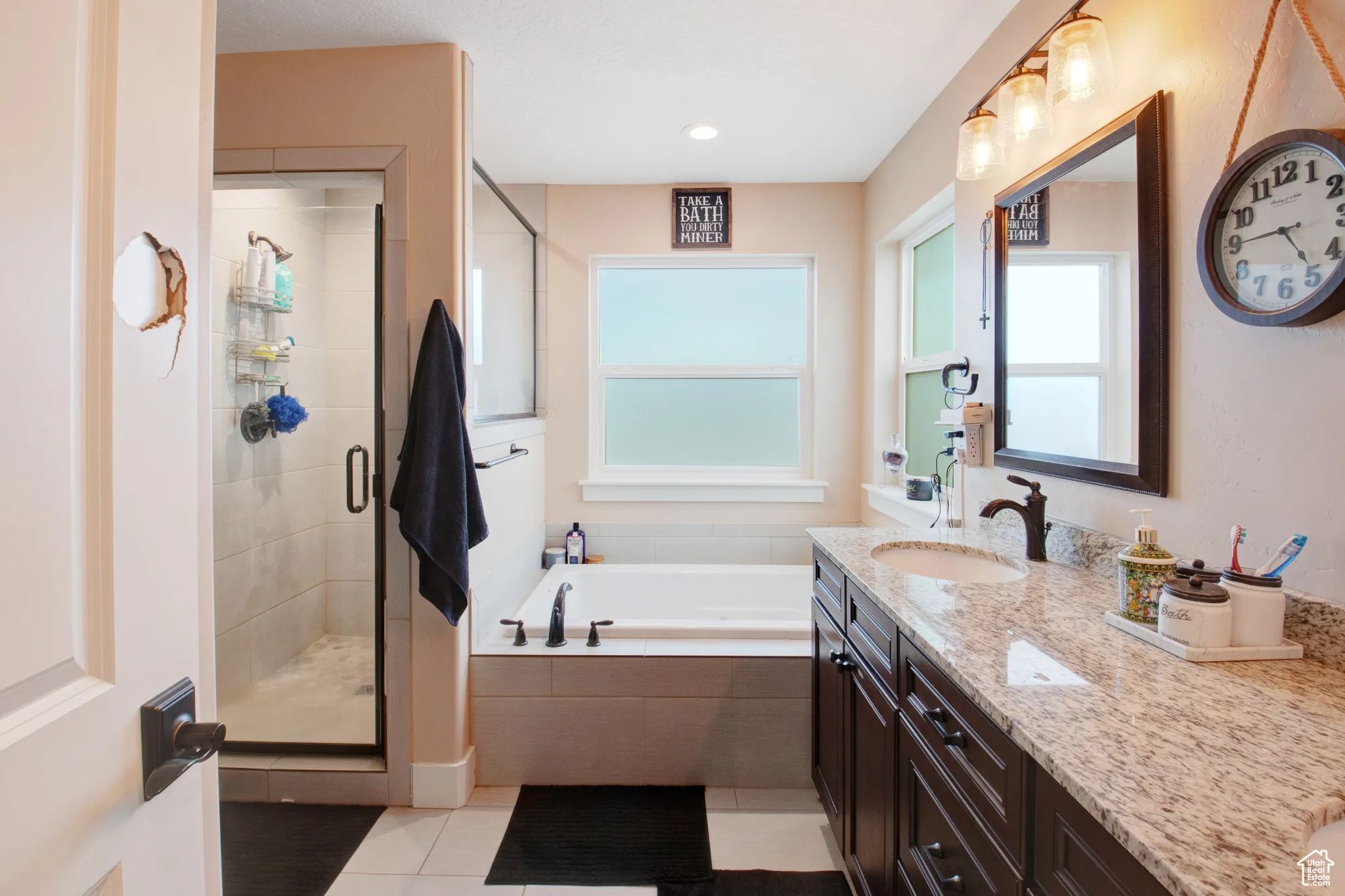 Bathroom featuring vanity, separate shower and tub, and tile patterned floors