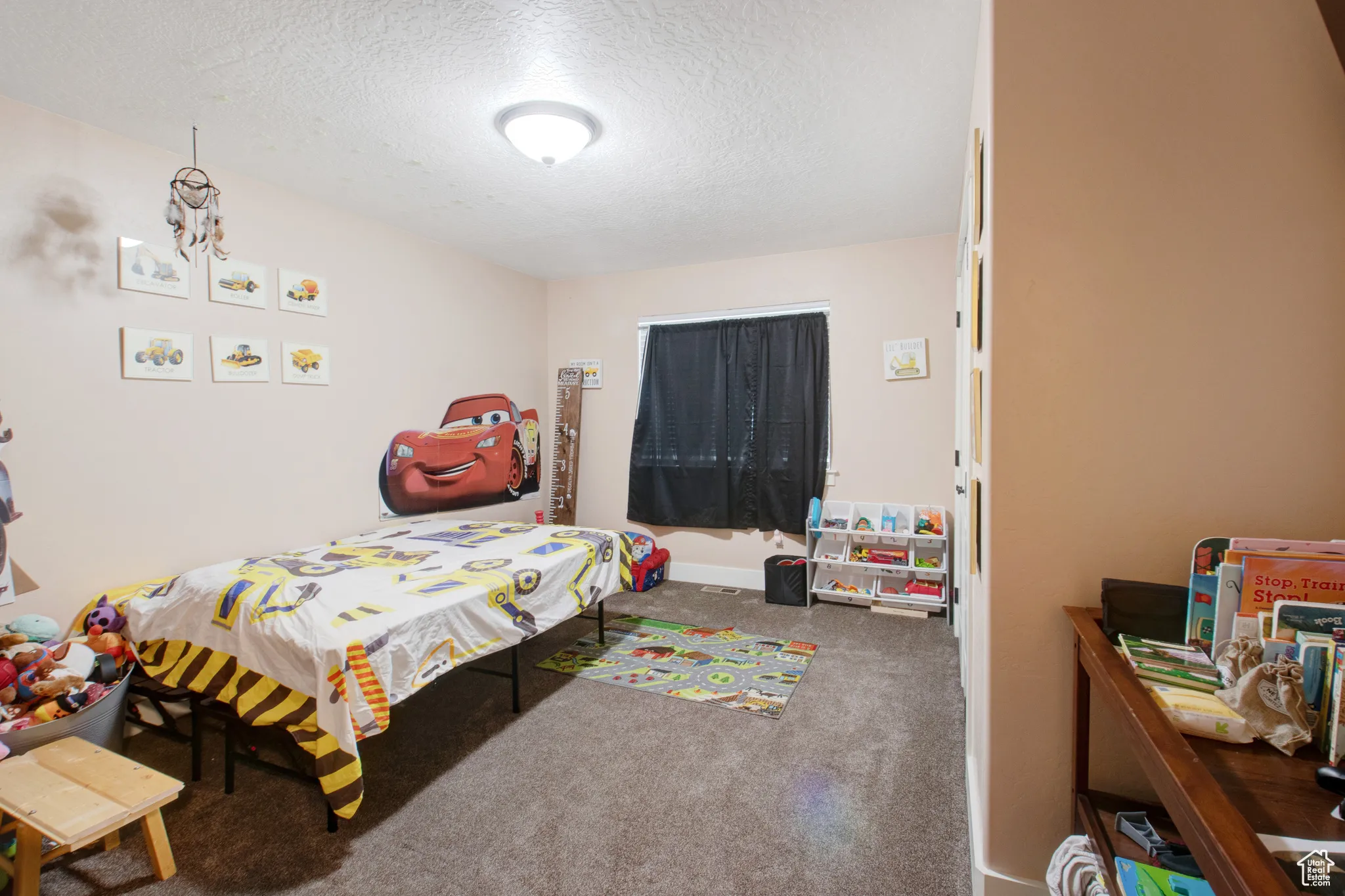 Bedroom with carpet floors and a textured ceiling
