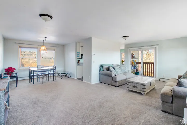 Carpeted living room featuring a baseboard radiator