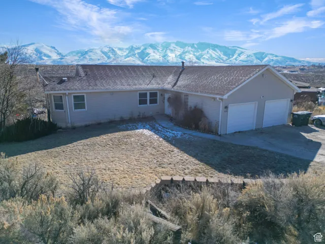 Ranch-style house featuring a garage and a mountain view