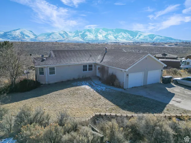 Exterior space with a garage and a mountain view