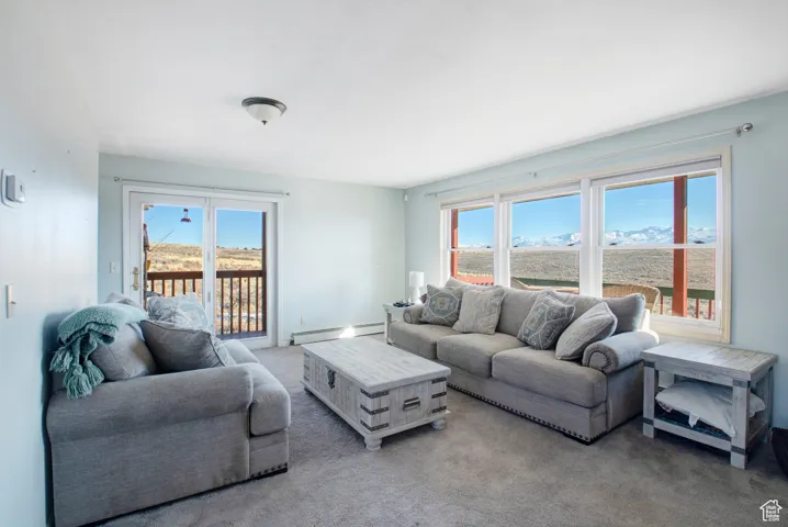 Carpeted living room featuring baseboard heating