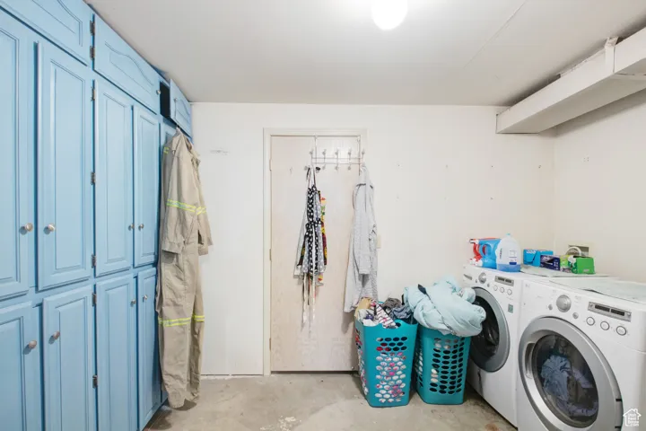 Laundry area featuring cabinets and washing machine and dryer
