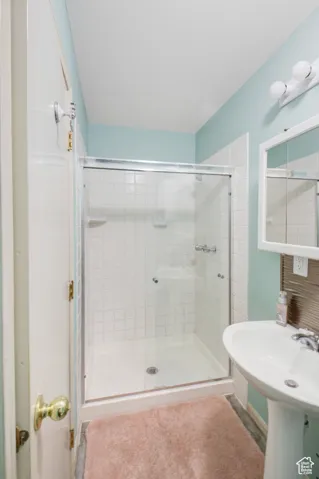 Bathroom with a shower with shower door