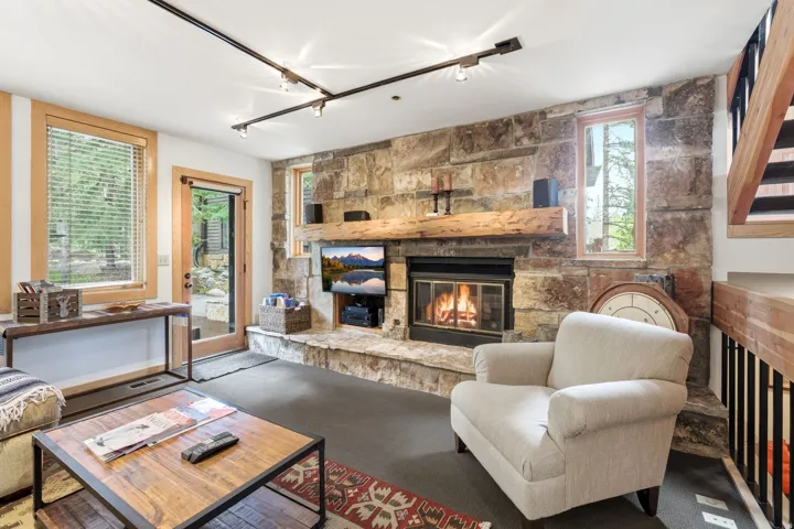Stone-clad fireplace with a substantial timber mantel