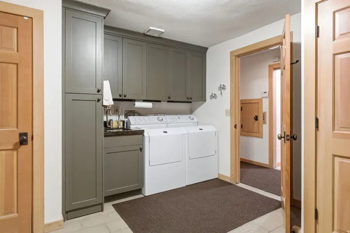 Utility room featuring light wood-finish doors and trim
