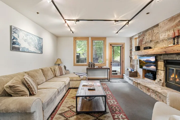 Stone-clad fireplace featuring a wood mantle and hearth