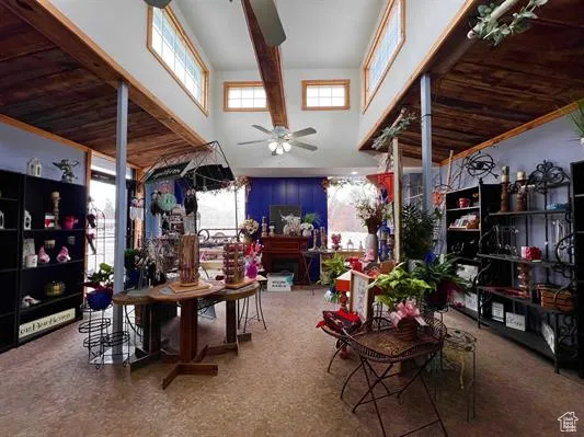 Dining space with ceiling fan, a healthy amount of sunlight, and a high ceiling
