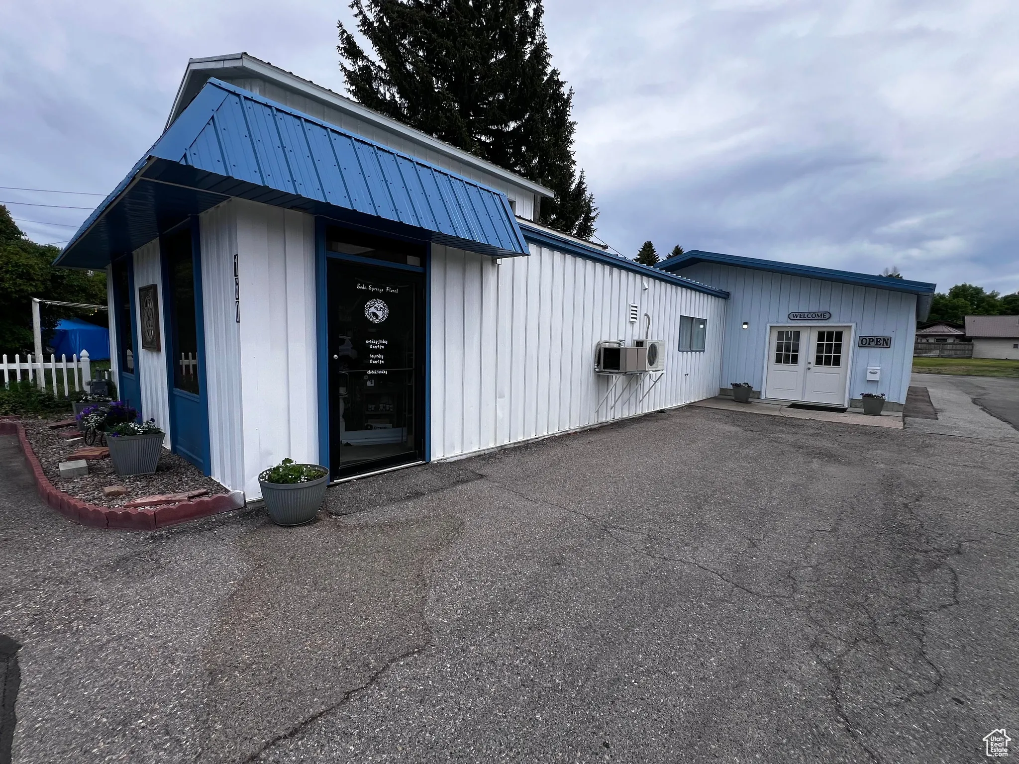 View of front of property featuring a metal roof, cooling unit, and a standing seam roof