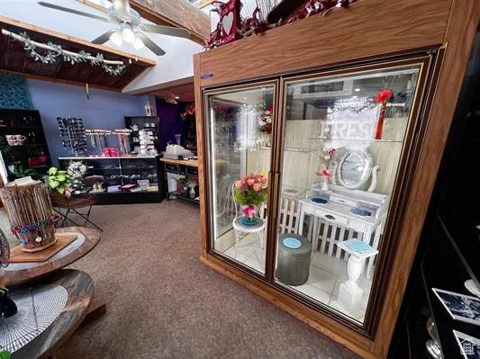 Interior space with ceiling fan and carpet flooring