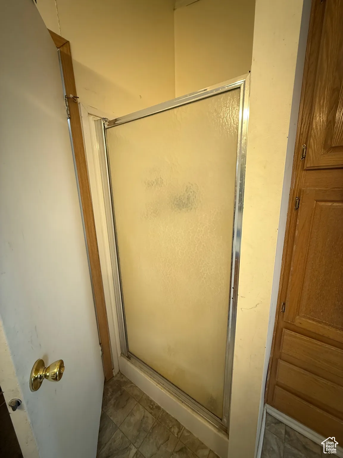 Bathroom featuring a shower with door